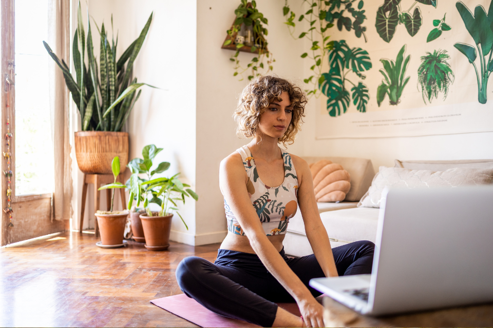 Women looking at her laptop and doing guided meditation
